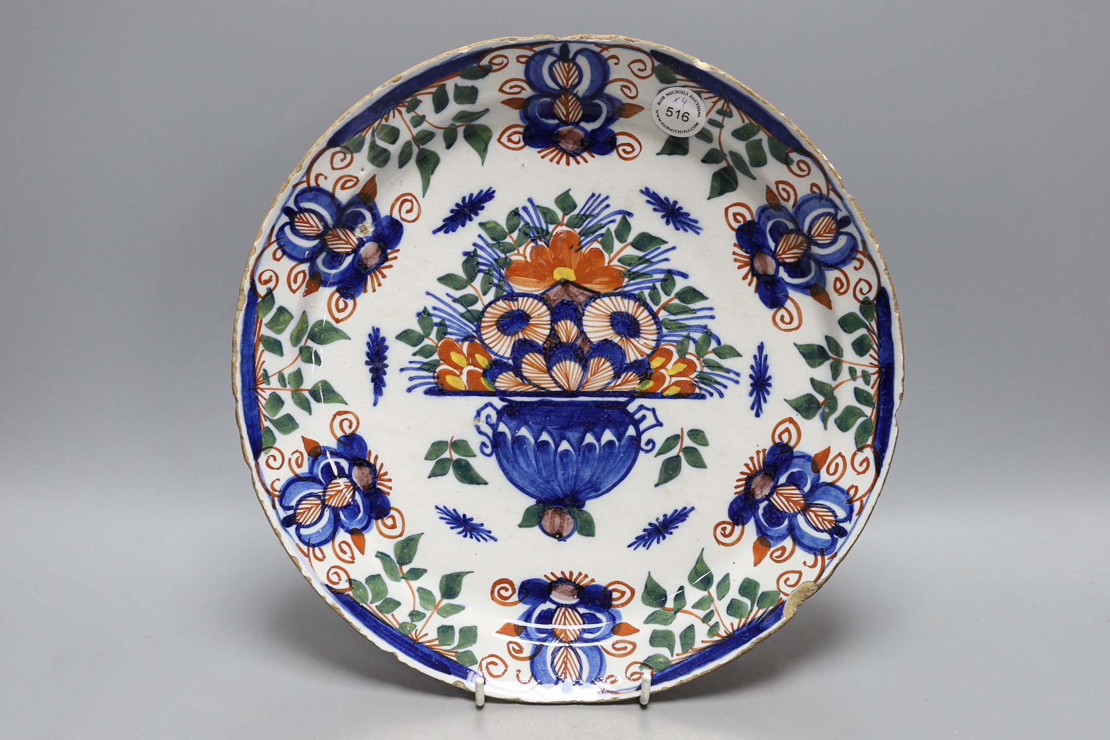 Four 18th century Dutch delft dishes, largest 30.5cm